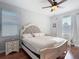 Bright main bedroom with hardwood floors, large windows, and comfortable bed at 3512 Gerrads Cross Ct, Land O Lakes, FL 34638