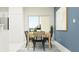 Inviting dining area with sleek furniture, a neutral color palette, and sliding glass door at 36095 Risa Michele St, Zephyrhills, FL 33541