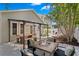 Inviting backyard with a wooden deck, dining table, fire pit, palm trees, and a grill in a separate area at 3620 W San Pedro St, Tampa, FL 33629