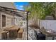 Backyard featuring a wooden deck, dining area, fire pit, privacy fence, tropical plants, and a storage shed at 3620 W San Pedro St, Tampa, FL 33629