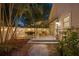 Backyard at dusk with deck, table, foliage, and string lights at 3620 W San Pedro St, Tampa, FL 33629
