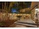 Backyard featuring outdoor dining on a deck with string lights, palms, and a privacy fence at 3620 W San Pedro St, Tampa, FL 33629