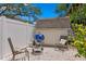Backyard with grill, gravel, shed, white fence and foliage at 3620 W San Pedro St, Tampa, FL 33629