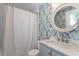 Charming bathroom featuring vanity, marble countertops, decorative wallpaper, and stylish shower curtain at 3620 W San Pedro St, Tampa, FL 33629