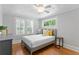 Cozy bedroom with wood floors, neutral walls, and a large window providing natural light at 3620 W San Pedro St, Tampa, FL 33629