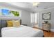 Comfortable bedroom with a plush bed, decorative pillows, and a window overlooking a green view at 3620 W San Pedro St, Tampa, FL 33629