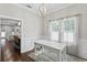 Bright dining room featuring white walls, dark wood floors, and a table on a gray shag rug at 3620 W San Pedro St, Tampa, FL 33629