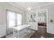 Dining room with dark wood floors, white wainscotting, and a white farmhouse table on a patterned rug at 3620 W San Pedro St, Tampa, FL 33629