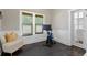 Bright exercise area featuring a modern workout bike, stylish chair, and natural light from the window with custom blinds at 3620 W San Pedro St, Tampa, FL 33629