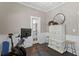 A stylish exercise room with a modern workout bike, cabinet, mirror, and natural light coming from a door to another room at 3620 W San Pedro St, Tampa, FL 33629