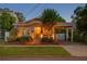 Charming home featuring manicured landscaping, a well-lit porch, and a cozy front yard at 3620 W San Pedro St, Tampa, FL 33629