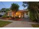Lovely bungalow-style home with inviting front porch, landscaped yard, and charming brick walkway and driveway at 3620 W San Pedro St, Tampa, FL 33629