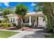 Charming home featuring a brick walkway, front porch with swing, and side carport at 3620 W San Pedro St, Tampa, FL 33629