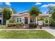 Charming single-story home with a welcoming front porch and beautiful landscaping on a manicured lawn at 3620 W San Pedro St, Tampa, FL 33629