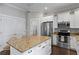 Kitchen with white cabinetry, stainless steel appliances, granite island and adjacent breakfast bar at 3620 W San Pedro St, Tampa, FL 33629