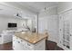 Bright kitchen featuring a granite island, white cabinets, and an open floor plan into the living room at 3620 W San Pedro St, Tampa, FL 33629