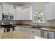 Kitchen with stainless appliances, granite countertops, and view of yard at 3620 W San Pedro St, Tampa, FL 33629