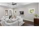 Comfortable living room with dark floors, ceiling fan, and built in tv at 3620 W San Pedro St, Tampa, FL 33629