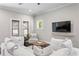 Comfortable living room with a cozy white sectional sofa, wood floors, and natural light at 3620 W San Pedro St, Tampa, FL 33629