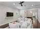 Open-concept living room with wood floors, a large sofa, and adjacent dining area at 3620 W San Pedro St, Tampa, FL 33629