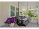 Inviting porch swing with decorative pillows and a side table adorned with flowers at 3620 W San Pedro St, Tampa, FL 33629
