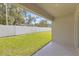 Covered patio with tile flooring and views of a large, green fenced-in backyard at 36628 Spanish Rose Dr, Dade City, FL 33525