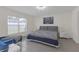 Inviting bedroom with a large window, chandelier lighting and neutral-toned decor at 36628 Spanish Rose Dr, Dade City, FL 33525