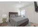 Comfortable bedroom featuring a queen bed, TV, and a bright window at 36628 Spanish Rose Dr, Dade City, FL 33525