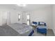Bright bedroom with access to the en-suite bathroom and a comfortable seating area with a chair at 36628 Spanish Rose Dr, Dade City, FL 33525