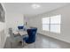 Bright dining room with modern lighting, and a table with stylish blue and gray chairs at 36628 Spanish Rose Dr, Dade City, FL 33525