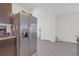 Kitchen featuring stainless steel appliances, dark wood cabinets, and tile flooring at 36628 Spanish Rose Dr, Dade City, FL 33525