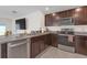 Kitchen with stainless steel appliances, dark wood cabinets and granite countertops at 36628 Spanish Rose Dr, Dade City, FL 33525