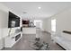 This living room has a huge TV, an open floor plan that connects to the kitchen, and a modern sectional sofa at 36628 Spanish Rose Dr, Dade City, FL 33525