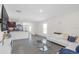 The Living Room features a modern white leather sectional sofa and open floor plan that connects to the kitchen at 36628 Spanish Rose Dr, Dade City, FL 33525