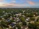 Aerial view of the area showcasing a sunset, nearby trees, streets and neighborhood at 4515 W Leona St, Tampa, FL 33629
