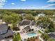 Aerial view of the home showcasing its pool, spa, patio, and mature trees at 4515 W Leona St, Tampa, FL 33629