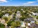 Aerial view of the neighborhood showcasing mature trees, nearby homes and proximity to the water at 4515 W Leona St, Tampa, FL 33629