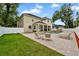 Expansive backyard featuring a sparkling pool, spa, patio, and lush green lawn at 4515 W Leona St, Tampa, FL 33629
