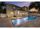 The backyard features a sparkling in-ground pool and spa plus a covered patio for outdoor living at 4515 W Leona St, Tampa, FL 33629