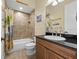 Cozy bathroom with a shower-tub combination and a dark granite countertop at 4515 W Leona St, Tampa, FL 33629