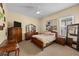 Spacious bedroom with a large window, light carpet, and dark furniture at 4515 W Leona St, Tampa, FL 33629