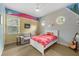 Unique bedroom featuring artistic wall decorations, a ceiling fan, and two circular windows at 4515 W Leona St, Tampa, FL 33629