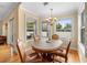 Bright dining area featuring wood floors, tan walls, and pool views at 4515 W Leona St, Tampa, FL 33629