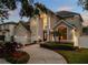 Stunning two-story home with a grand entrance, manicured landscaping, and a three-car garage at 4515 W Leona St, Tampa, FL 33629