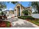 Attractive two-story home featuring a large double door entry, three car garage, and manicured landscaping at 4515 W Leona St, Tampa, FL 33629