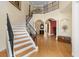 The grand two-story foyer features an impressive staircase, hardwood floors, and plenty of natural light at 4515 W Leona St, Tampa, FL 33629