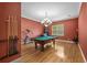 Spacious game room with a pool table, hardwood floors, decorative lighting, and large window at 4515 W Leona St, Tampa, FL 33629