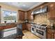 Gourmet kitchen with a professional-grade stove, custom cabinets, and a tile backsplash at 4515 W Leona St, Tampa, FL 33629