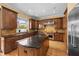 Spacious kitchen featuring custom cabinetry, granite countertops, and stainless steel appliances at 4515 W Leona St, Tampa, FL 33629