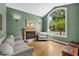 Inviting living room featuring a fireplace, large window, and hardwood floors at 4515 W Leona St, Tampa, FL 33629